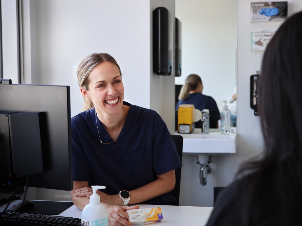 Friendly GP talking to patient